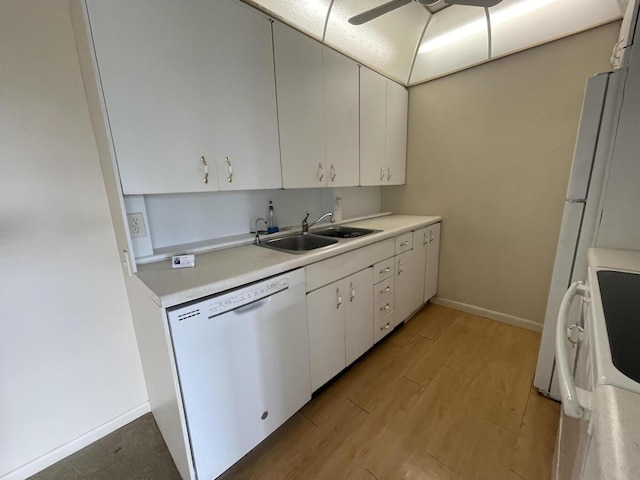 kitchen with sink, white cabinets, white appliances, and light hardwood / wood-style floors