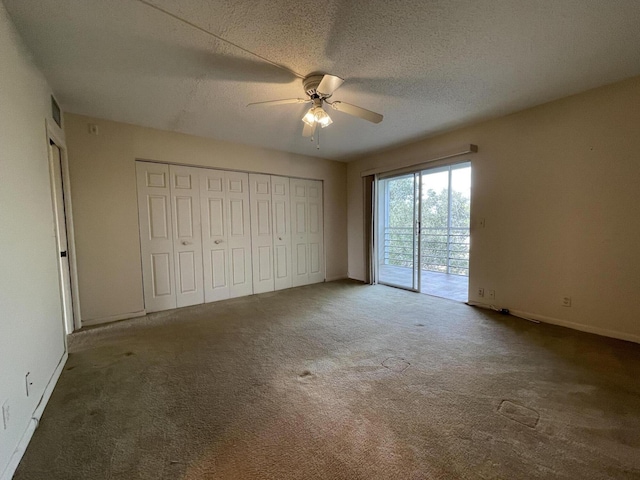 unfurnished bedroom featuring ceiling fan, carpet flooring, access to exterior, and a textured ceiling