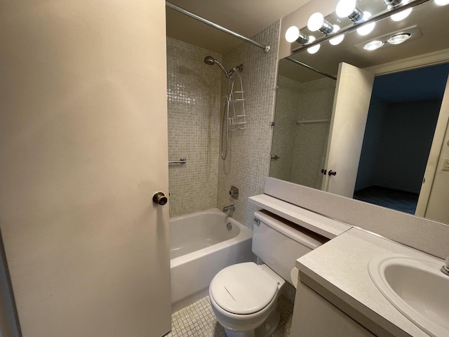 full bathroom featuring vanity, toilet, tiled shower / bath combo, and tile patterned flooring