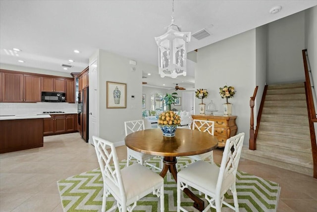 dining room with ceiling fan and light tile patterned flooring