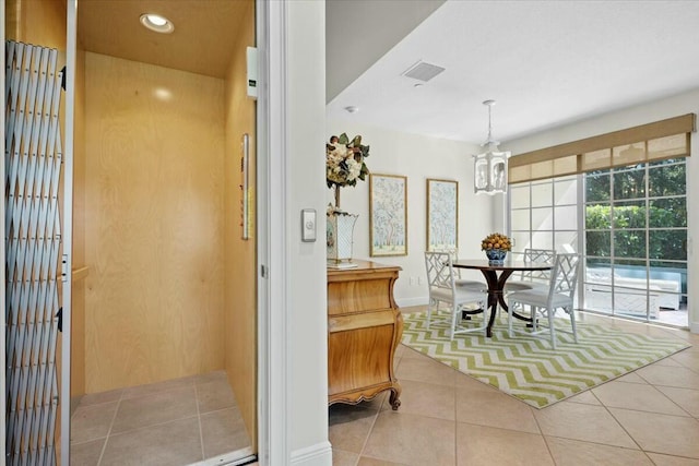 interior space with a chandelier and elevator