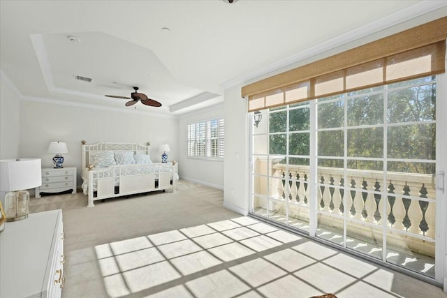 unfurnished bedroom with access to exterior, light carpet, a raised ceiling, and ceiling fan