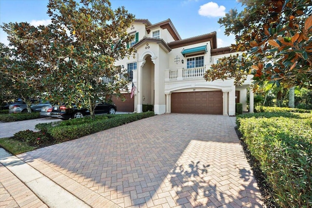 mediterranean / spanish-style house featuring a balcony and a garage