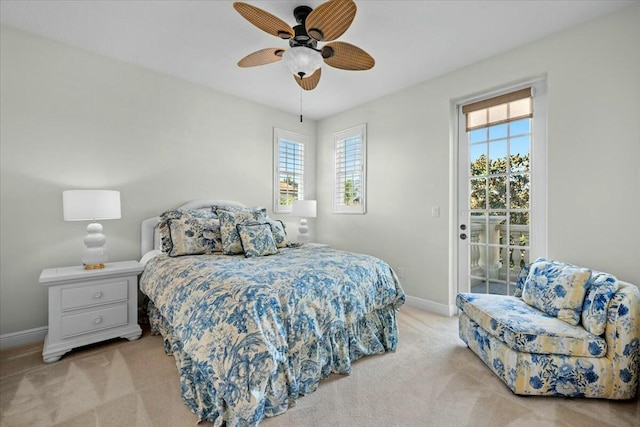 bedroom featuring ceiling fan, light carpet, access to outside, and multiple windows