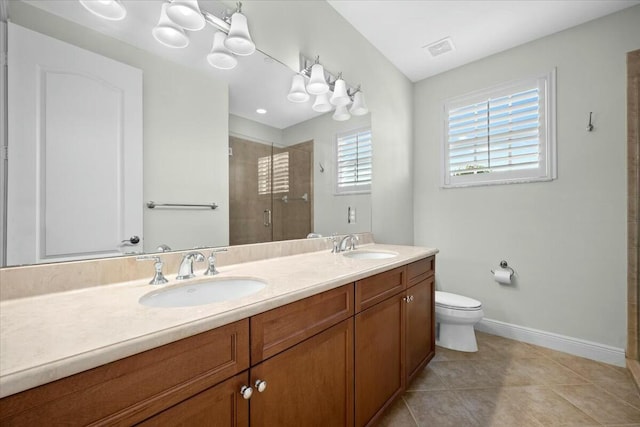 bathroom featuring tile patterned floors, vanity, toilet, and walk in shower