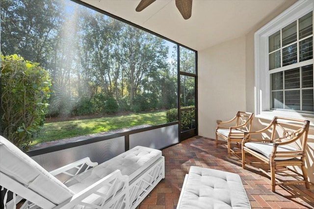 sunroom featuring ceiling fan