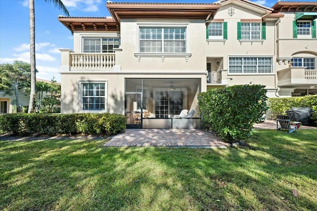 rear view of property featuring a patio area and a yard