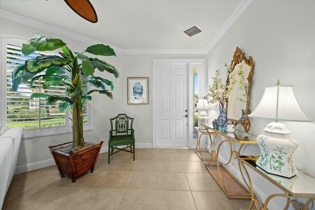 entrance foyer with ceiling fan, light tile patterned floors, and ornamental molding