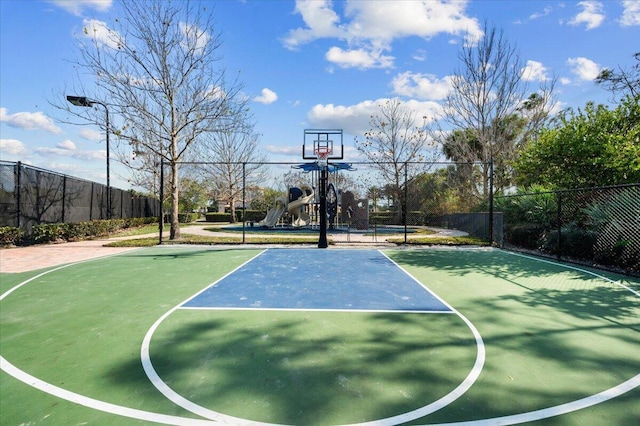 view of basketball court with a playground