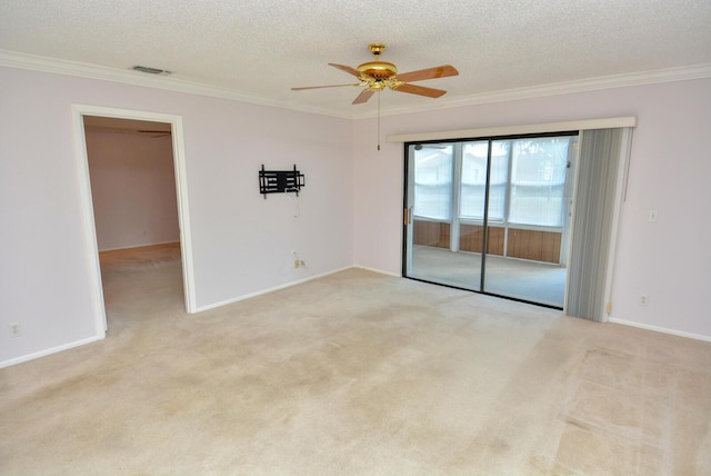 carpeted empty room featuring a textured ceiling, ceiling fan, and ornamental molding