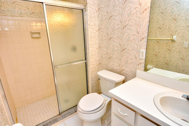 bathroom with vanity, toilet, and walk in shower