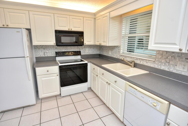 kitchen with white cabinets, sink, light tile patterned floors, and white appliances