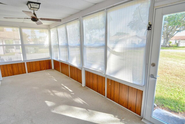 unfurnished sunroom with ceiling fan