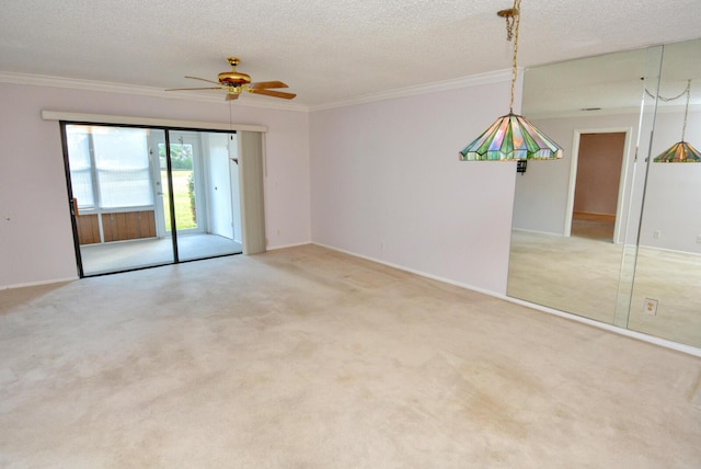 empty room with a textured ceiling, ceiling fan, ornamental molding, and light carpet