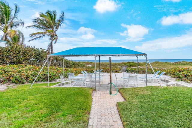 exterior space featuring a lawn and a water view