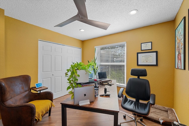 office area featuring ceiling fan, hardwood / wood-style floors, and a textured ceiling