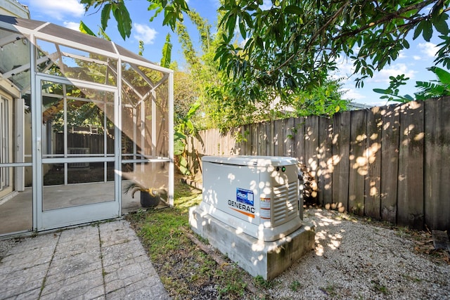 view of patio featuring glass enclosure