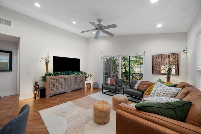 living room with wood-type flooring, a textured ceiling, high vaulted ceiling, and ceiling fan