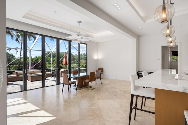 dining room with ceiling fan, french doors, and a raised ceiling