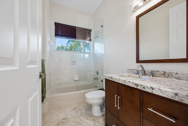 full bathroom with toilet, vanity, and tiled shower / bath