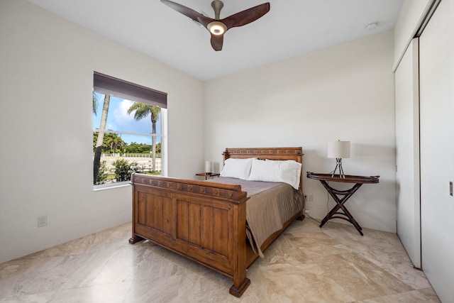 bedroom with ceiling fan and a closet