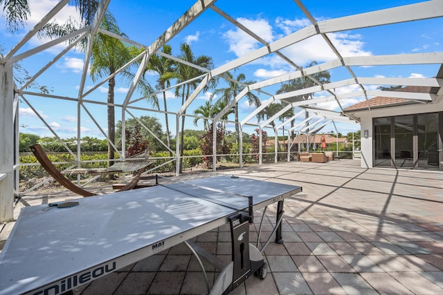 view of patio / terrace featuring a lanai