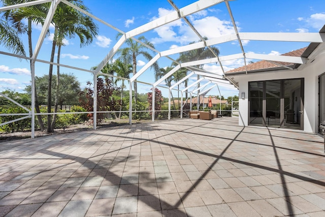 view of patio / terrace featuring a lanai