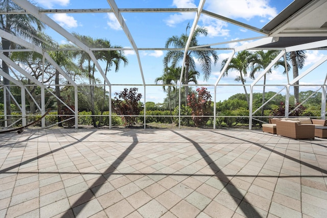 view of patio / terrace featuring an outdoor hangout area and glass enclosure