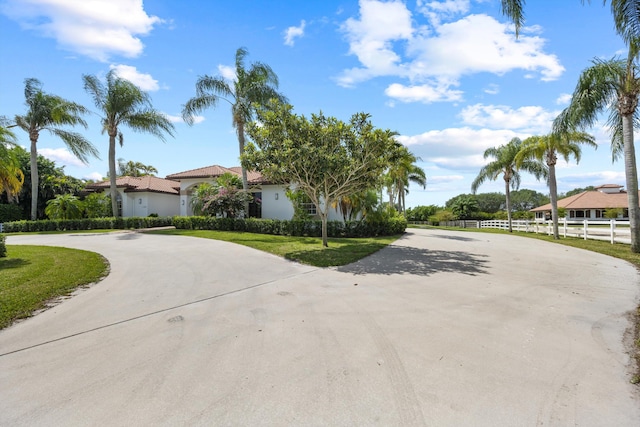 mediterranean / spanish home with a front lawn