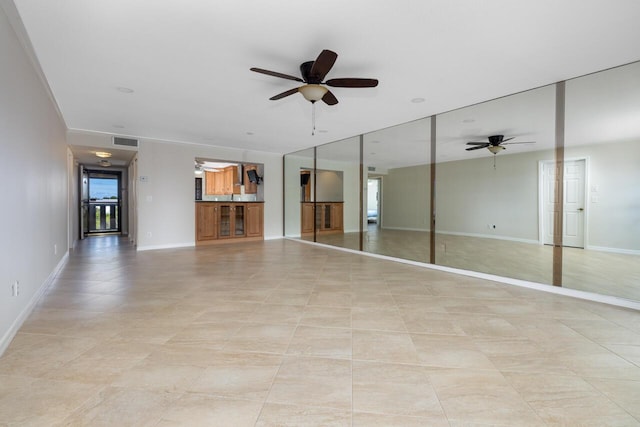 spare room featuring ceiling fan and light tile patterned floors