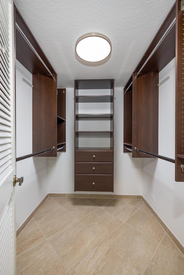 walk in closet featuring light tile patterned floors