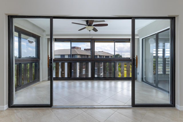 unfurnished sunroom with plenty of natural light and ceiling fan