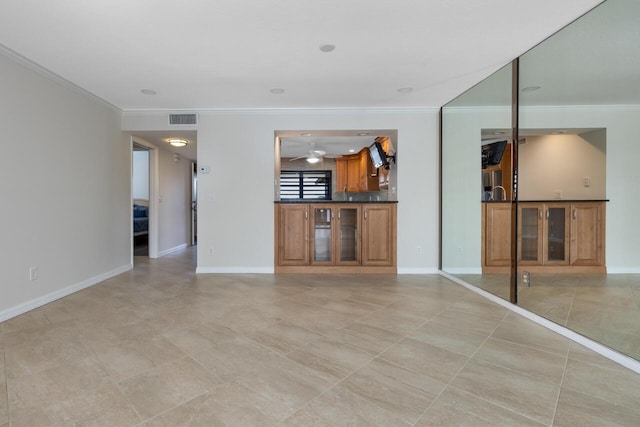 unfurnished living room featuring ceiling fan and ornamental molding