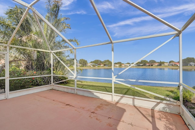 unfurnished sunroom with a water view