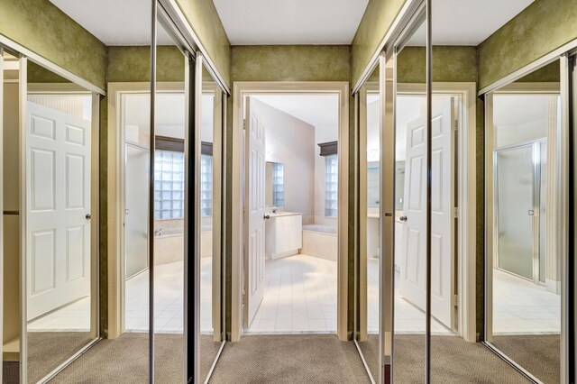 carpeted bedroom with ceiling fan and a closet