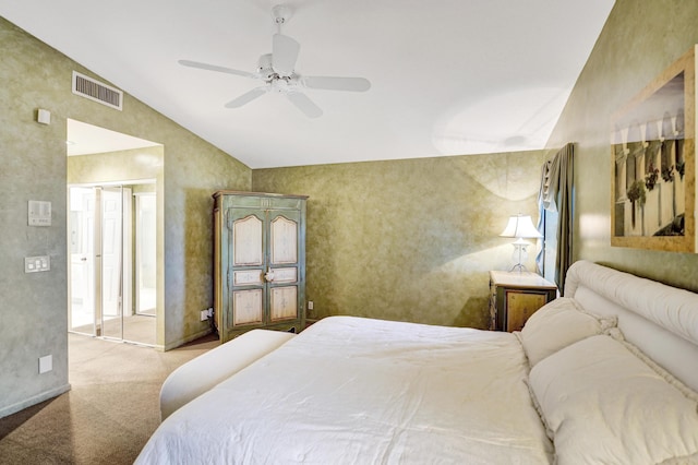 bedroom featuring lofted ceiling, ceiling fan, a closet, and light carpet