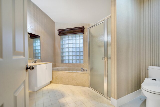 bathroom with independent shower and bath, tile patterned floors, and vanity