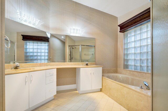 bathroom featuring lofted ceiling, a shower with door, tile patterned floors, and vanity