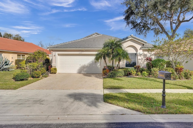 view of front of home with a front yard and a garage