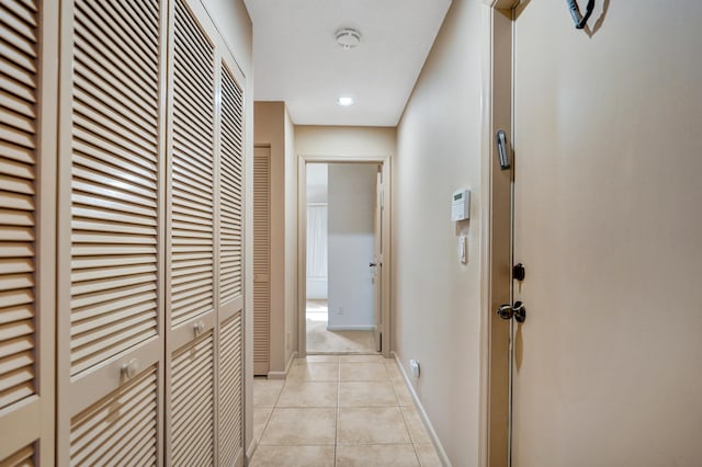 hall featuring light tile patterned floors