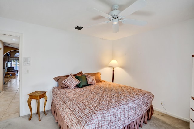 tiled bedroom with ceiling fan