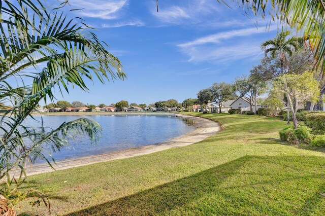 view of patio featuring a lanai and a water view