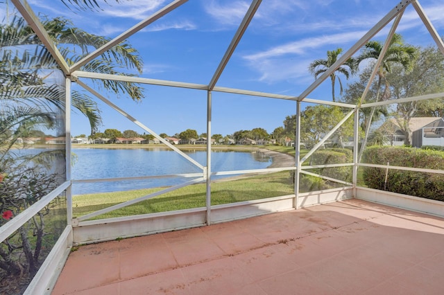 unfurnished sunroom featuring a water view