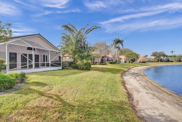 view of yard featuring a lanai and a water view