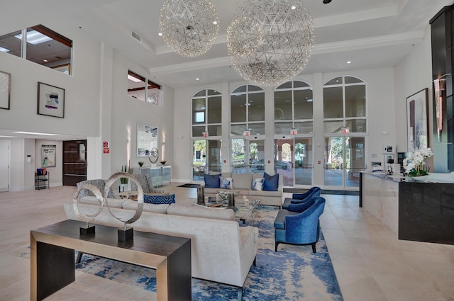 living room featuring crown molding, french doors, a towering ceiling, and a chandelier