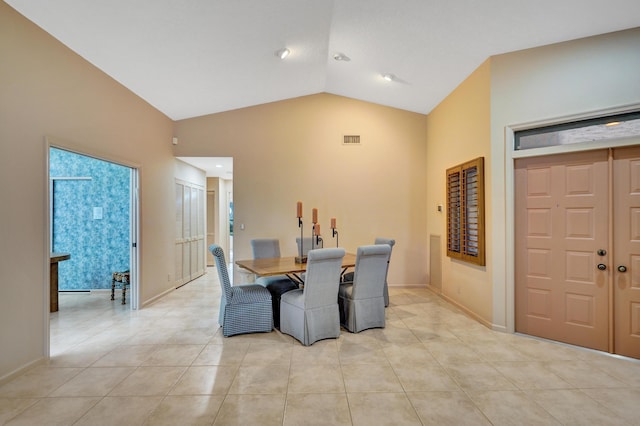 tiled dining room featuring lofted ceiling