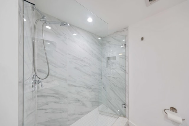 bathroom featuring a shower with shower door