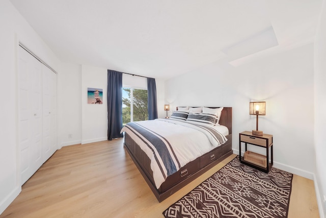 bedroom with a closet and light hardwood / wood-style flooring