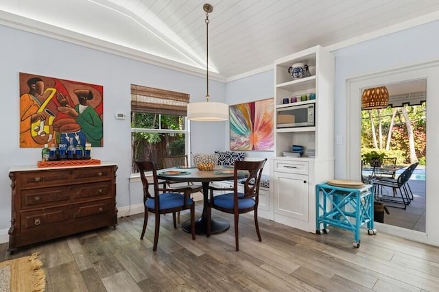 dining space with a healthy amount of sunlight, wood-type flooring, lofted ceiling, and wood ceiling