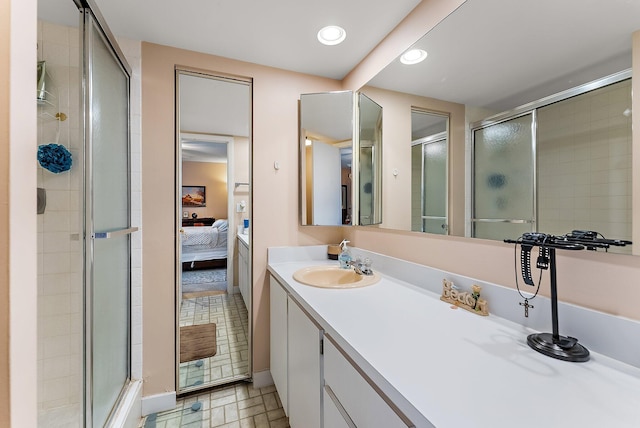 bathroom with vanity and a shower with shower door